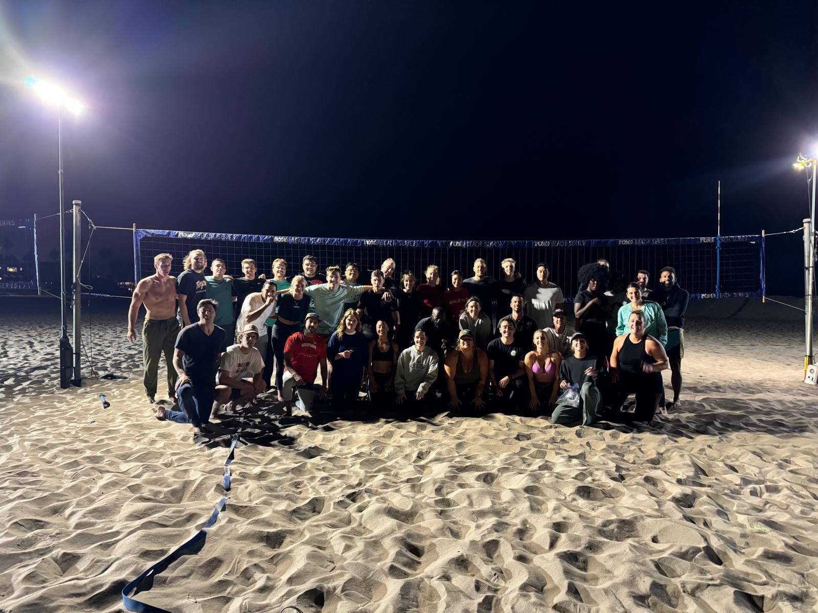 A large OBVB evening volleyball group under court lights